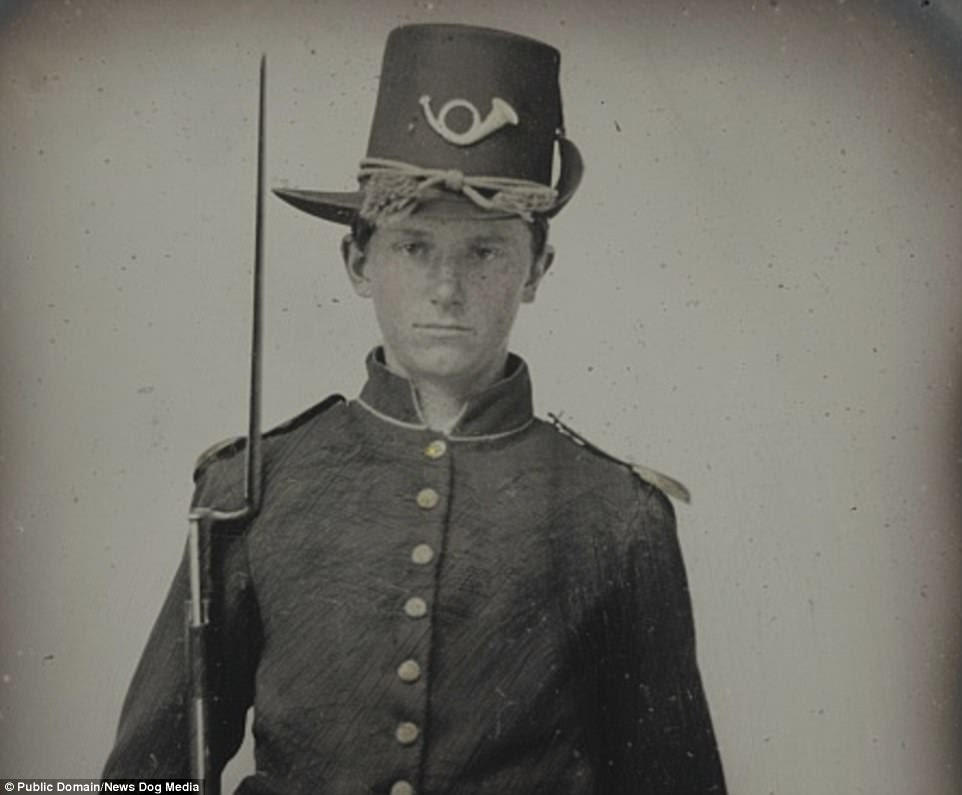 A Union child soldier poses with his rifle. Countless other children fought, with white children carrying drums, bugles, and guns and black children working as servants for white officers