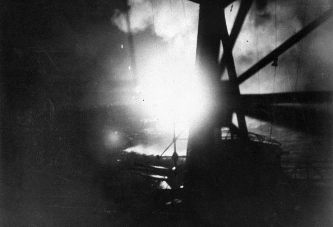 This photograph taken from the deck of the Japanese cruiser Chokai shows flares illuminating the American cruiser USS Chicago and the Australian cruiser Camberra on the night of August 8-9, 1942.