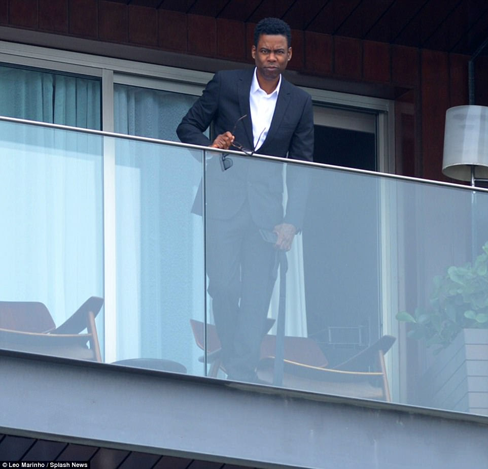 Star-studded: Actor and comedian Chris Rock appeared on the balcony of the luxury beachfront hotel, which the couple have paid $150,000 to hire for their famous friends