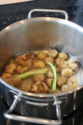 Chestnuts boiling in stock with celery and thyme