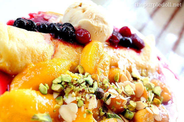 Freshly-Made Crepe with Banana, Mangoes and Mixed Berries topped with White Chocolate Raspberry Ice Cream, Pistachios and Almonds