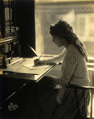 English: Mary Pickford writing at a desk