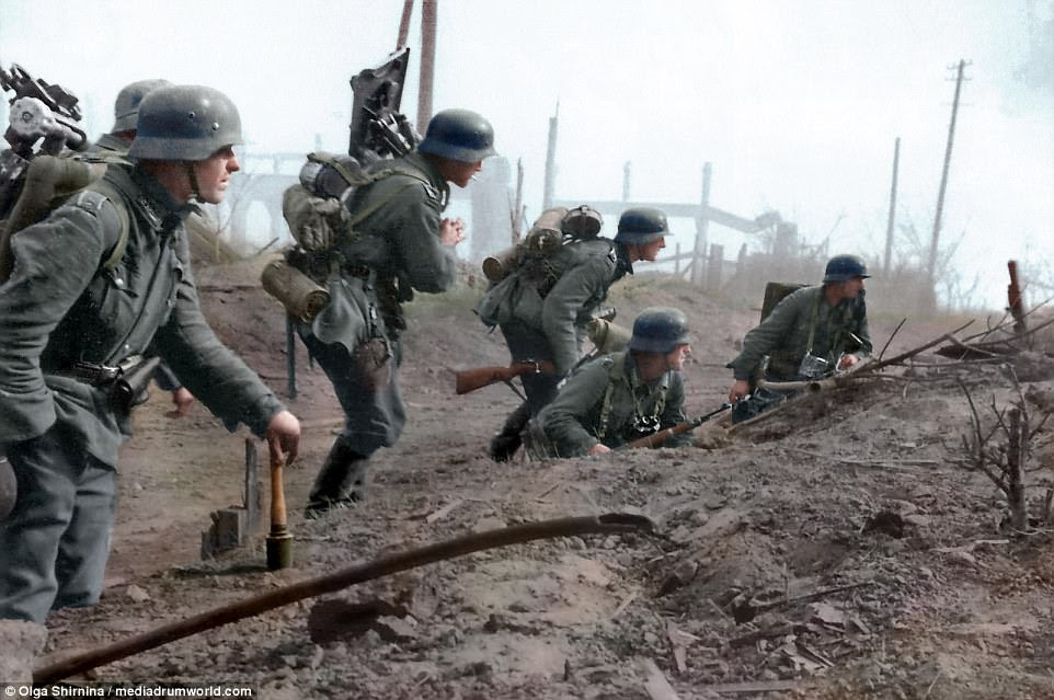 The colourised pictures show a soviet soldier victoriously hoisting a flag over the city of Stalingrad, German troops of the 6th Army making their move into the suburbs of Stalingrad, in 1942. The 6th Army was a field army unit of the German Wehrmacht during World War Two. The 6th Army is still widely remembered for its destruction by the Red Army at the Battle of Stalingrad in the winter of 1942 and 43. It is also infamous for the war crimes, such as the massacre of more than 30,000 Jews at Babi Yar, it committed under the command of Field Marshal Walther von Reichenau during Operation Barbarossa in 1941