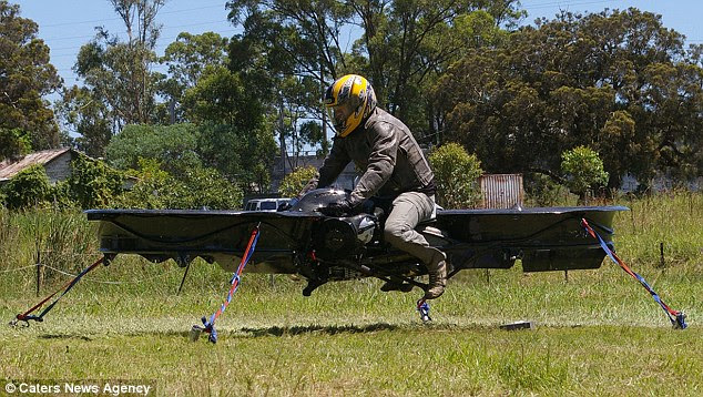 Futuristic: Helicopter pilot Chris Malloy tests his incredible contraption - the world's first flying motorcycle