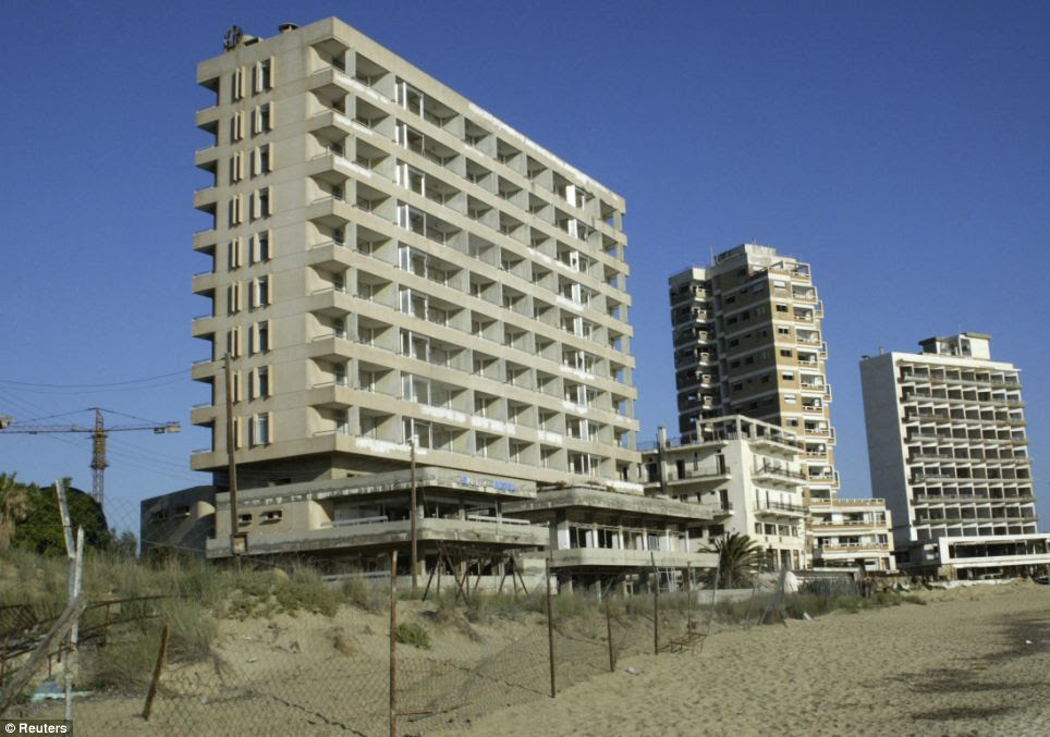 Derelict apartment blocks and crumbling hotels riddled with bullet holes sit on empty beaches behind barbed-wire fencing after Varosha's 15,000 residents fled in 1974
