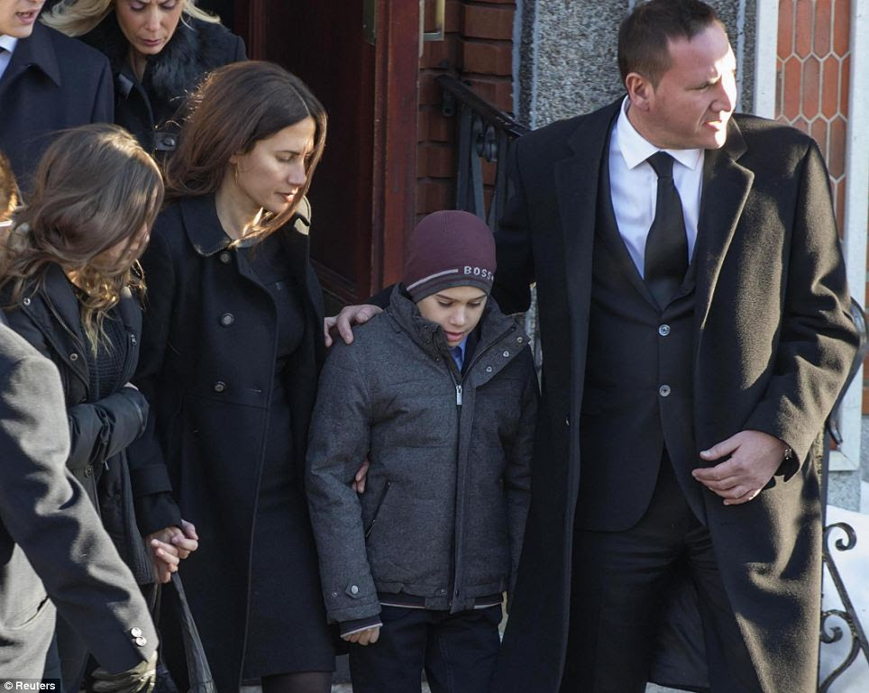 Members of the Rizzuto family leave the Montreal church after the Mafia boss's funeral. His son Leonardo was among the mourners