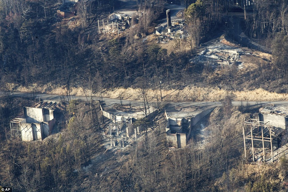 Burned structures are seen from aboard a National Guard helicopter after fires spread quickly on Monday night, when winds topping 87 mph whipped up the flames