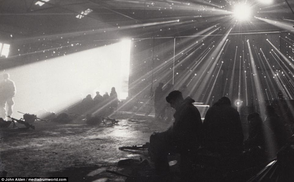 Light streams through the bullet holes left in a corrugated hangar, which troops took shelter in during the Falklands fighting