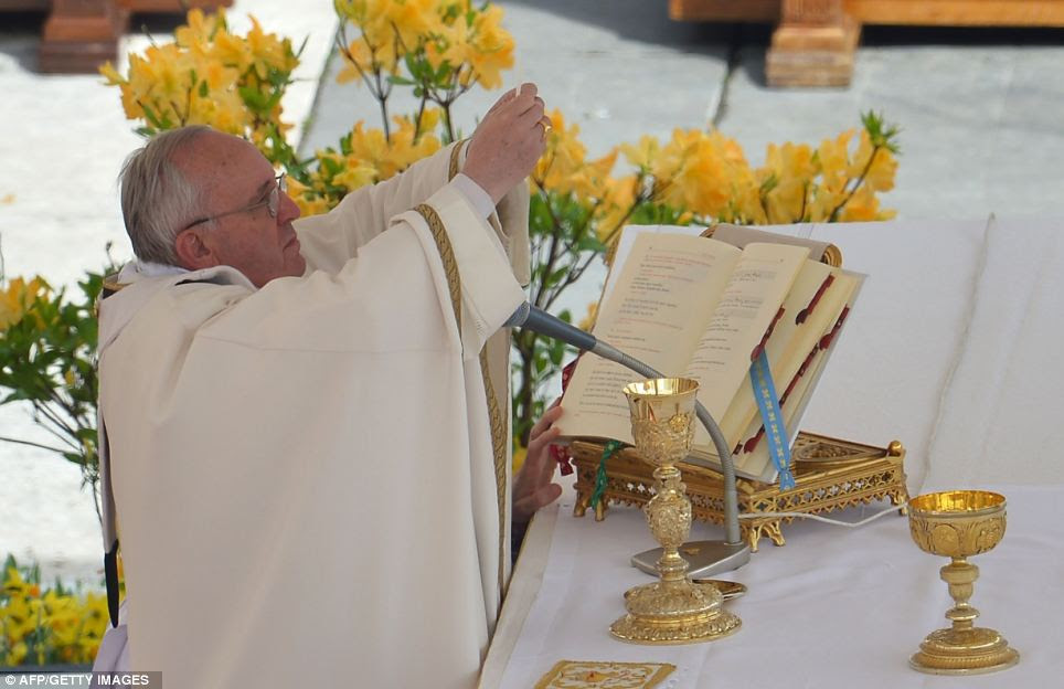 Communion: Pope Francis celebrates the Eucharist during the Easter service today