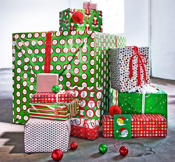 A pile of Christmas presents wrapped in green/red/white gift wrap in different patterns