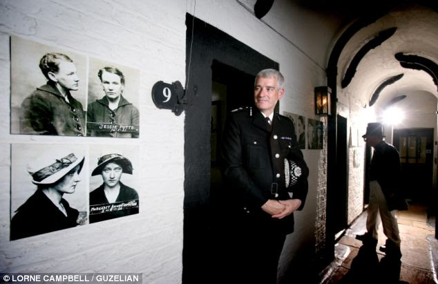 Dave Jones, Chief Constable of North Yorkshire Police alongside the pictures of some of the criminals his predecessors helped apprehend