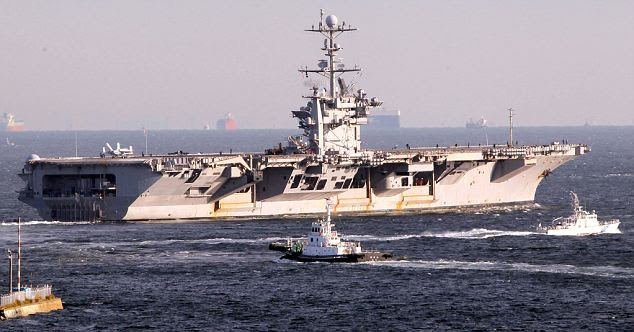 On patrol: The U.S. military aircraft carrier USS George Washington sets sail from Yokosuka naval base, south of Tokyo, heading to Korean waters