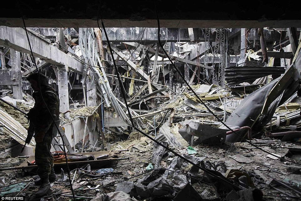 Obliterated: An armed soldier of the separatist self-proclaimed Donetsk People's Republic army stands inside the damaged Donetsk airport