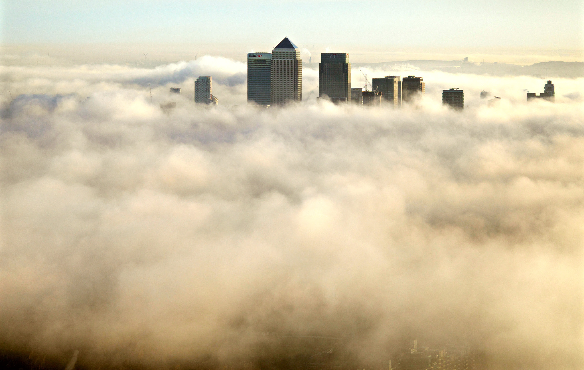 Canary Wharf and the fog around London as seen from the Shard