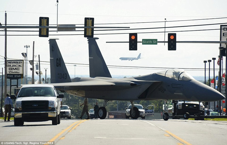 Sixth Street: Airmen maneuver through traffic lights while towing an F-15 Eagle to the Warner Robins City Hall in Warner Robins, Georgia. The aircraft was loaned to the city by the Georgia Air National Guard's 116th Air Control Wing to serve as a static display for a new veteran's memorial