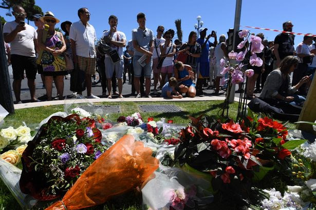 Flowers and candles placed near the site in Nice where a gunman smashed a truck into a crowd of revellers celebrating Bastille Day, killing at least 84 people