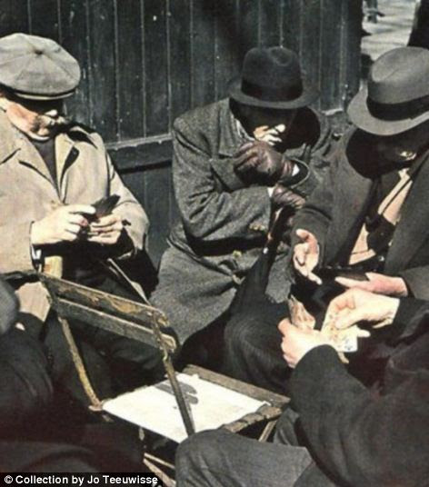 and elderly men huddle around a chair as they play cards (right) 