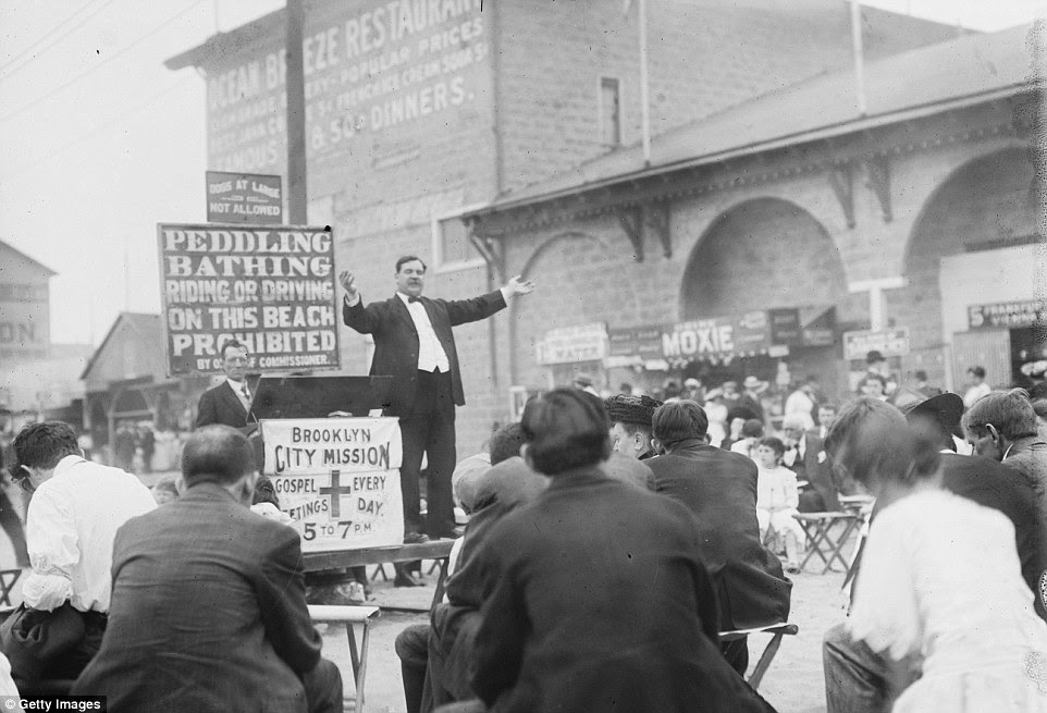 In the midst of revelling, a preacher from the Brookyln City Mission speaks to crowds who have gathered on the beaches (circa 1900)