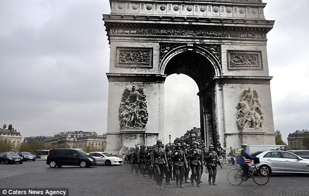 German soldiers march down the streets of France near the famous Arc de Triomphe