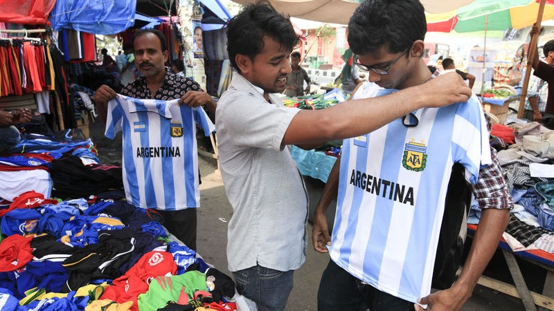Football fans buy Jerseys of their favourite teams from Bangladesh's Dhaka ahead of the FIFA World Cup. Image by Md. Asaduzzaman Pramanik. Copyright Demotix (19/5/2014)