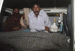 Mohammad Iqbal, right, husband of Farzana Parveen, …
