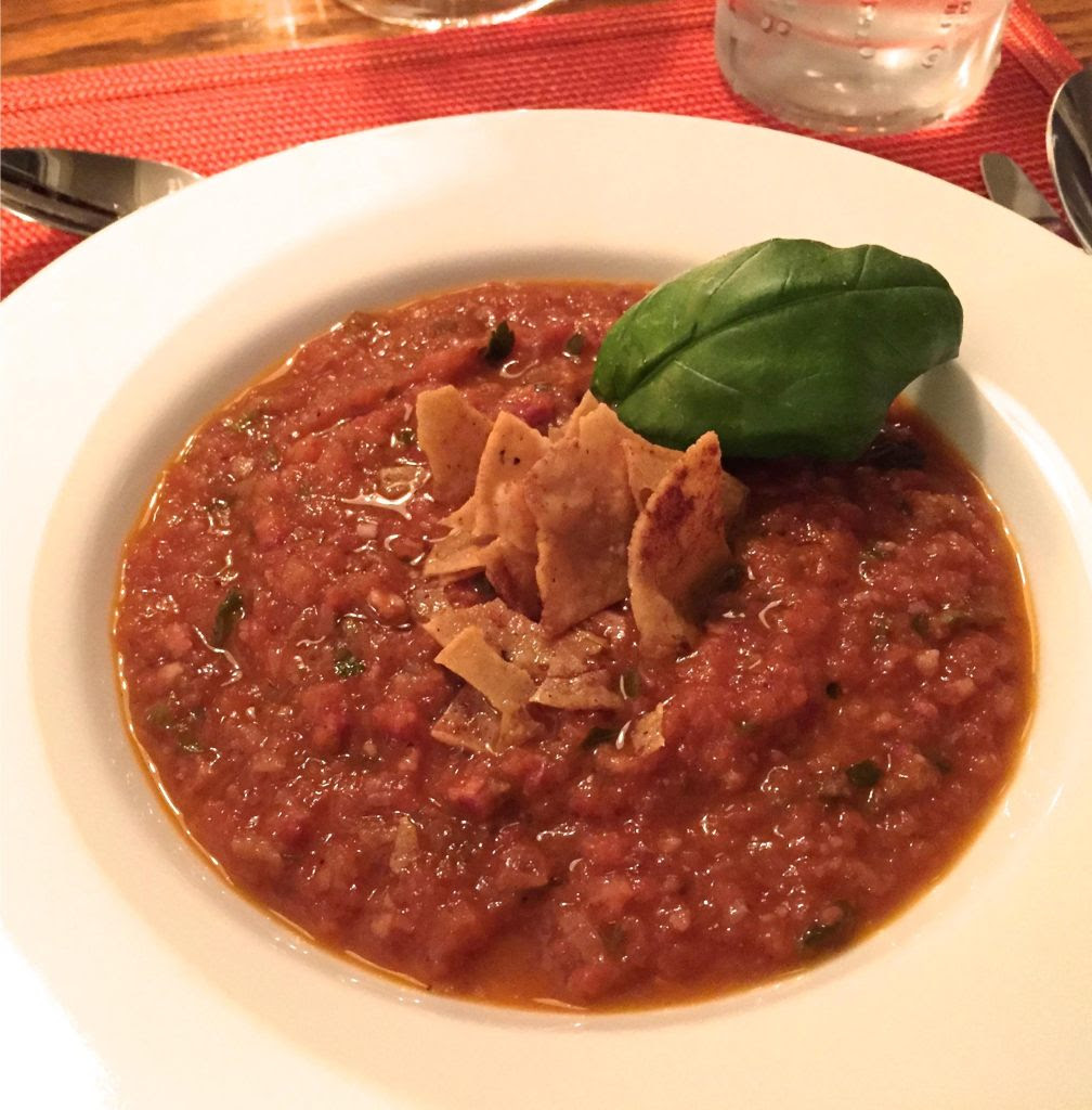 Smoked tomato soup in a white bowl.