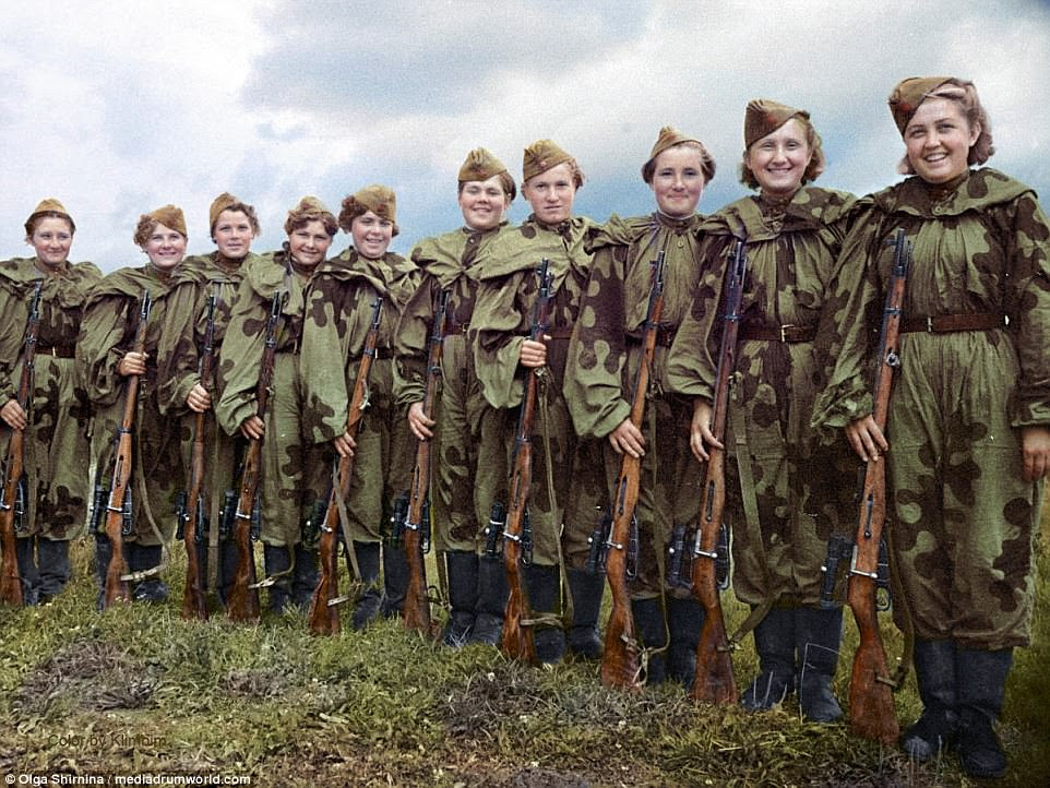 Taking up arms:  One colourised photograph shows a row of Soviet women holding their sniper rifles and ready to fight Nazi Germany