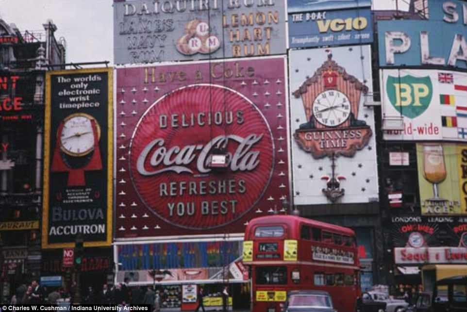 While this picture is unmistakably that of Piccadilly Circus, the scene is vastly different today's dizzying, illuminated billboards. Adverts for Coca-Cola, Guiness, British Petroleum and other can all be seen dominating the busy picture 
