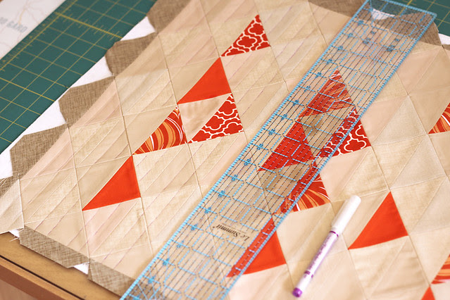 using a ruler to mark out quilting lines across the width