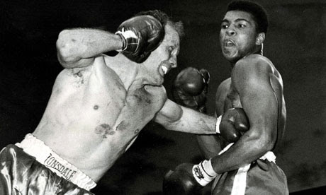 Henry Cooper lands a punch on Muhammad Ali  in their heavyweight title fight in June 1963