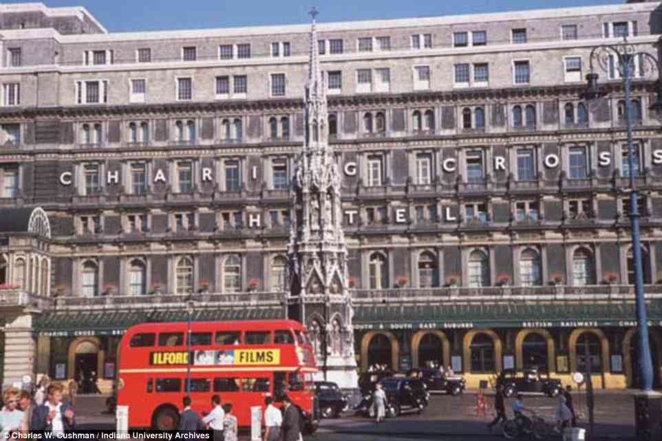 A quintessentially London double-decker buss rolls past Charing Cross Hotel as Londoners go about their business during a summer's day in 1961