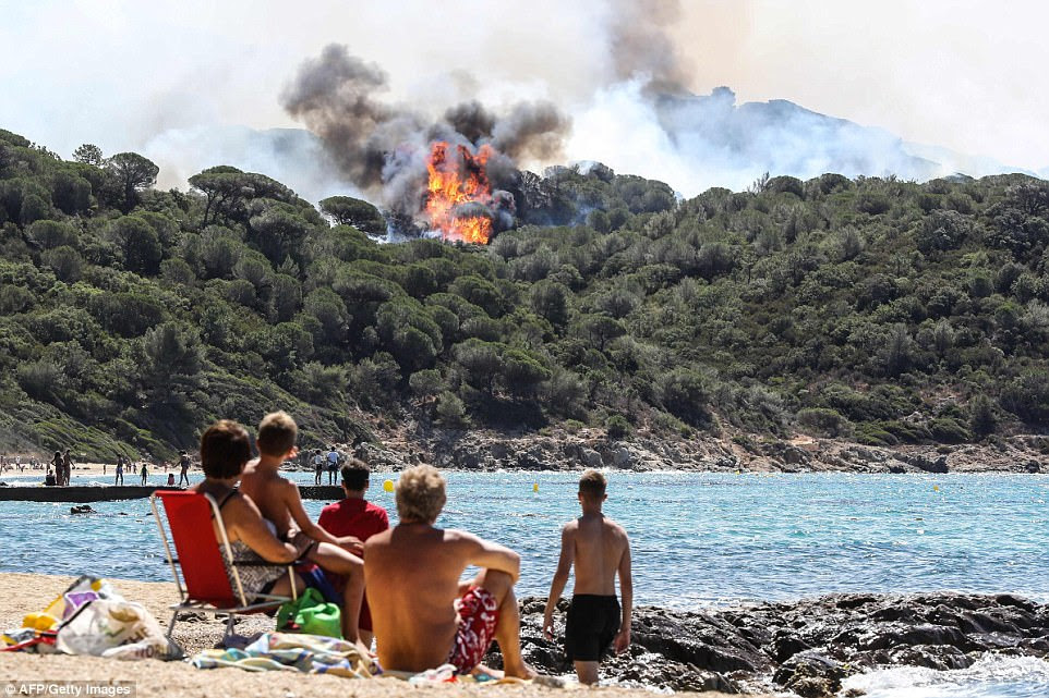 Tourists do their best to enjoy their holidays in the French Riviera while huge fires continue to rage in La Croix-Valmer, near Saint-Tropez