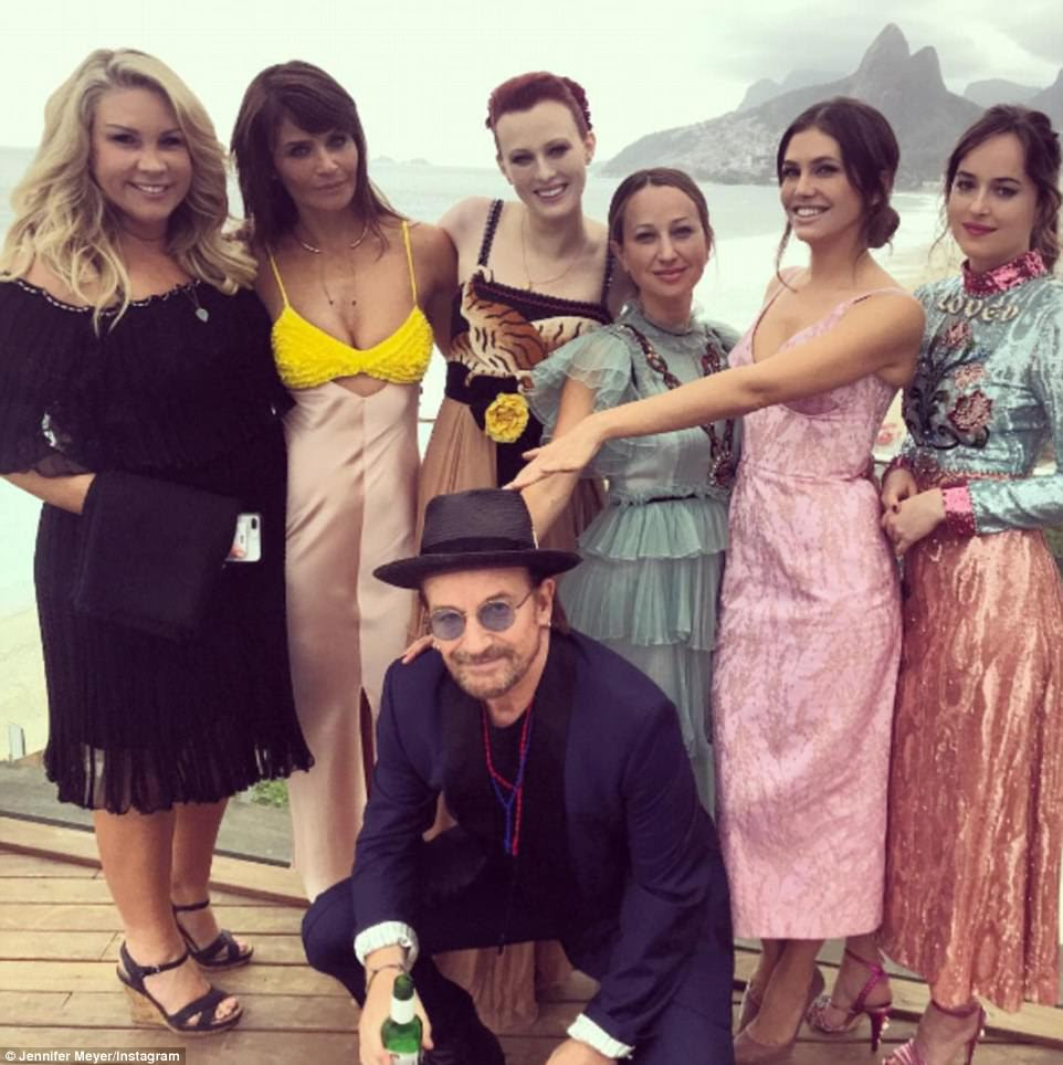 So many stars: Ahead of the wedding on Tuesday, Bono posed with Helena Christensen (second from left), Dakota Johnson (right), and Roman Abramovich's ex Dasha Zhukova (second from right)