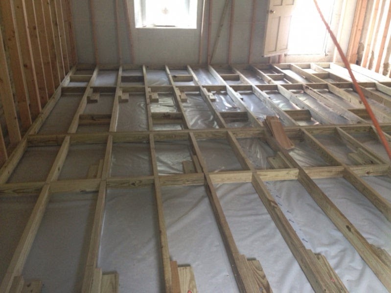 How to get Shed wood floor joists over concrete slab 