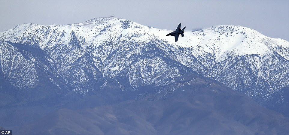 A F/A-18E Super Hornet from VFA-24 squadron at NAS Lemoore banks in front of the Panamint range while exiting Star Wars Canyon on February 27