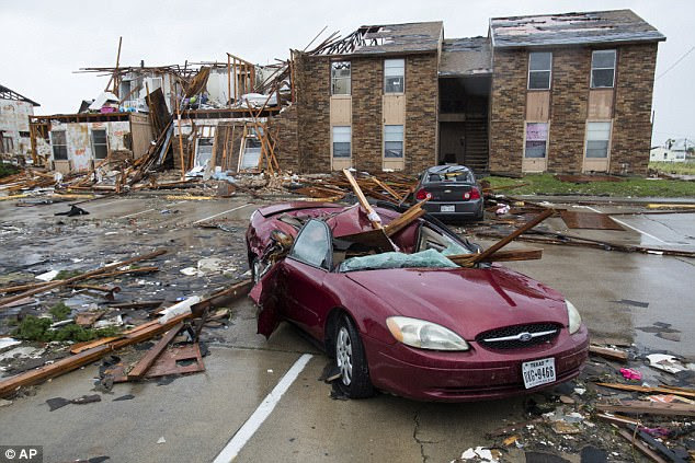 A damaged car sits outside a heavily damaged apartment complex in Rockport, Texas, after Hurricane Harvey. Rockport is about 45 minutes away from Stinton, where Otis is from