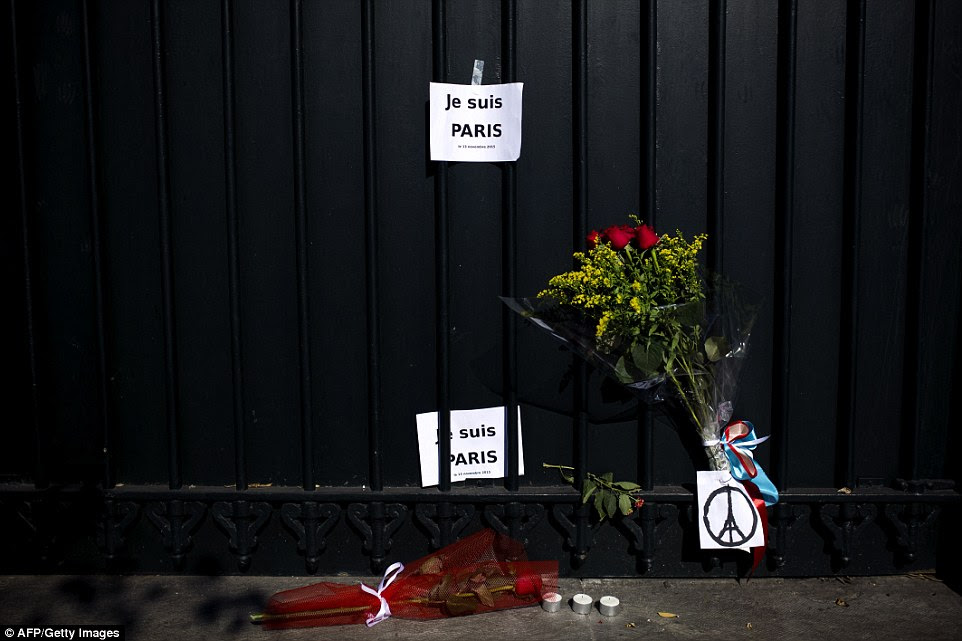 Notes reading, 'I am Paris' and flowers are seen outside French Embassy in Greece this morning
