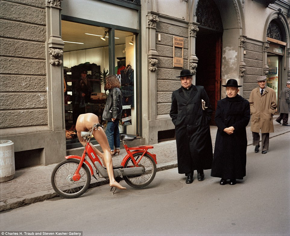 Two priests and a mannequin on a bicycle in Reggio Emilia in 1983. Many of Traub's photographs are laced with wry humour 