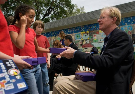 Actor and environmentalist Ed Begley Jr. right, signs a lunch box for Zoe Reese, 10, at Crocker/Riverside Elementary School during an event to celebrate Earth Day in 2008. The school in an affluent city neighborhood is seeing tension between two parent fundraising groups this year.