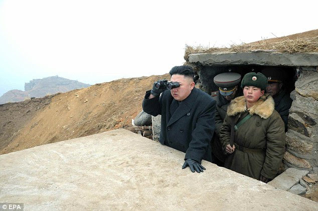 Kim Jong-un views South Korean islands through binoculars during a visit to a military unit on a western island