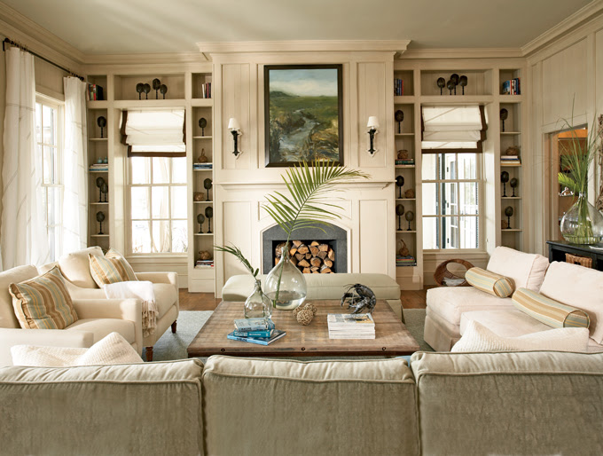 wine sphere demijohn as vase paneled ceiling and walls all neutral living room built in shelves around windows flanking fireplace