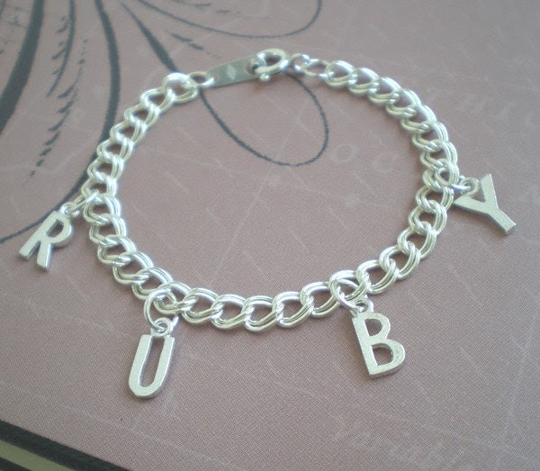 Lovely Sterling Silver bracelet for girl's spelling out their name with four letter charms or 3 letters and an open hear