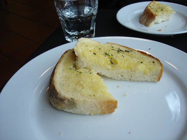 Kitschen - "Herb bread": White bread slices soaked with melted butter and a very little herbs on top.