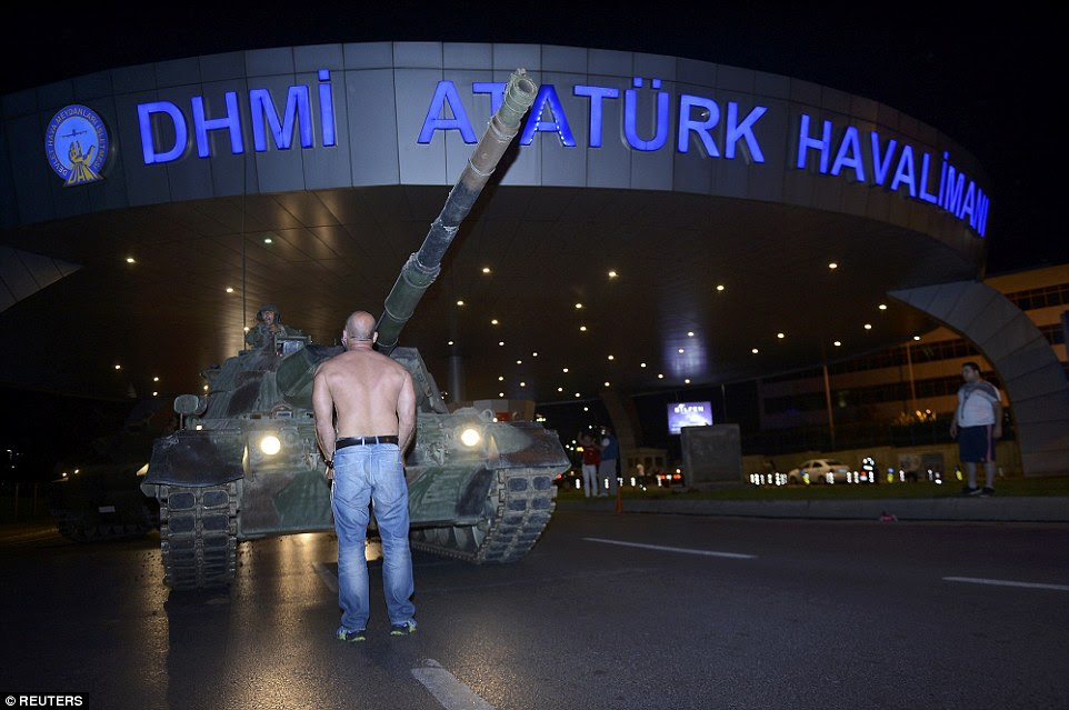 The man then stood up and took off his shirt in an effort the present the tank from taking position in the airport 