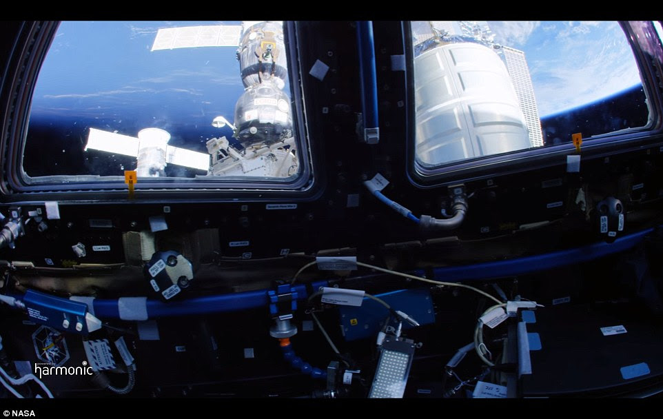 Another view from the cupola, showing a Soyuz resupply craft attached to it. Another view from the cupola, showing a Soyuz resupply craft attached to it.