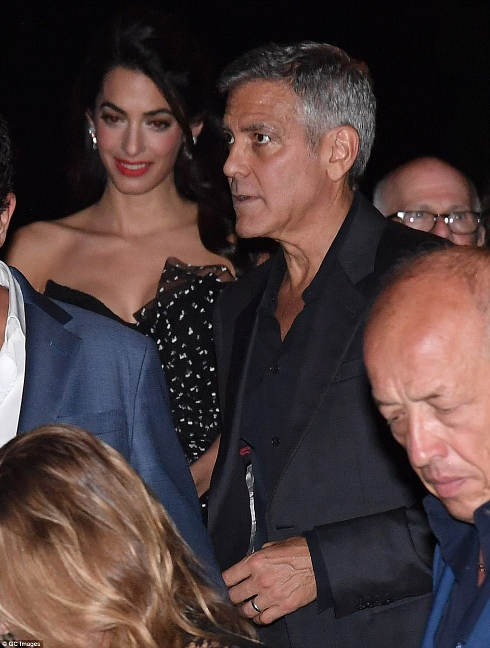 Here they come: The couple were making their first appearance in the picturesque Italian city following the birth of twins Ella and Alexander in June, and they were elegantly dressed as they exited the upmarket Hotel Cipriani