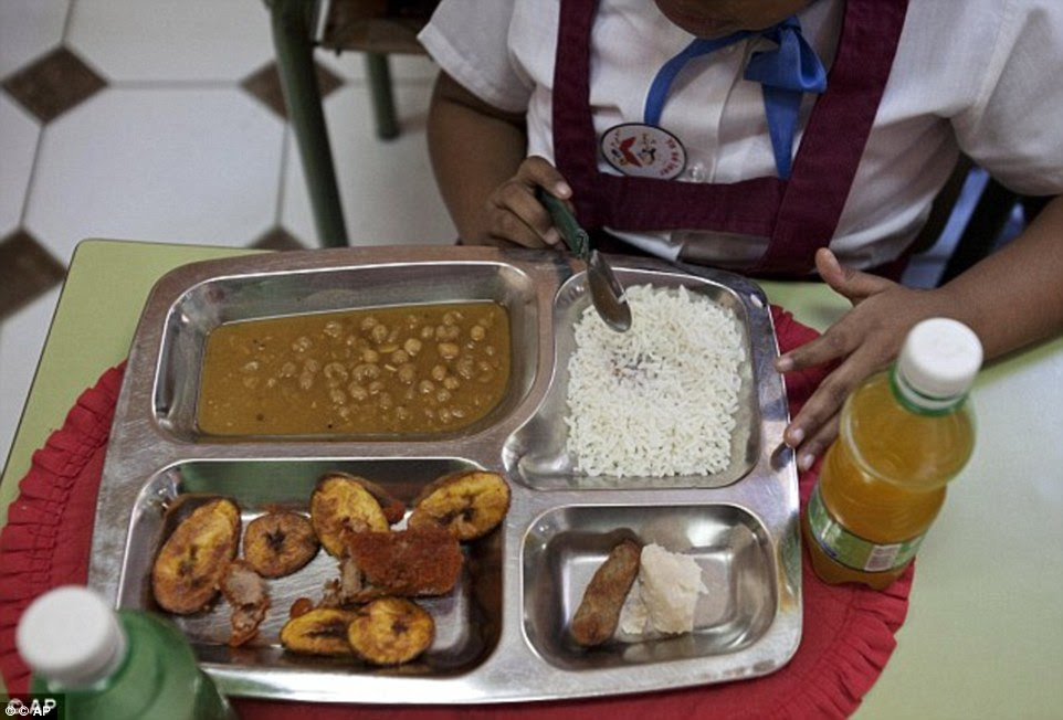 Rice, a chicken croquette, a piece of taro root and yellow pea soup is the school lunch in Old Havana, Cuba