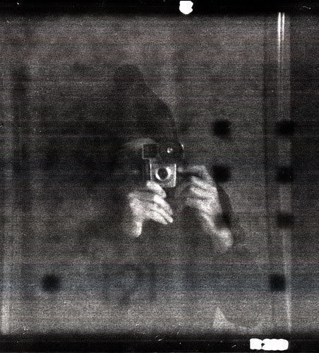 reflected self-portrait with Brownie Starmite camera and woolen hat by pho-Tony