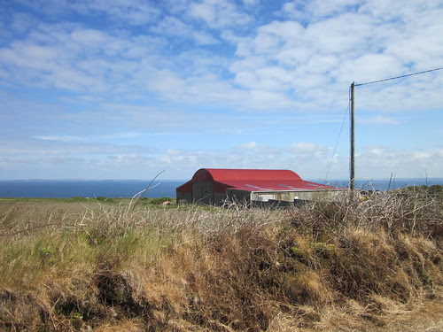 Red roof against an impossibly perfect sea and sky