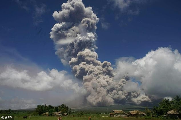 A giant mushroom-shaped cloud rises into the air from Mayon volcano - as experts predict a dangerous eruption
